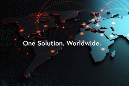 Dark world map with white text "One Solution. Worldwide." There are highlighted connections between many places in the world, everything is globally connected