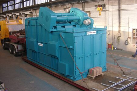 Light blue linear vibrating screen (as a hot mineral screening machine) ready for transportation on a heavy-duty truck.