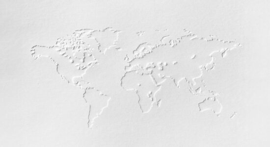 White world map on white textured paper